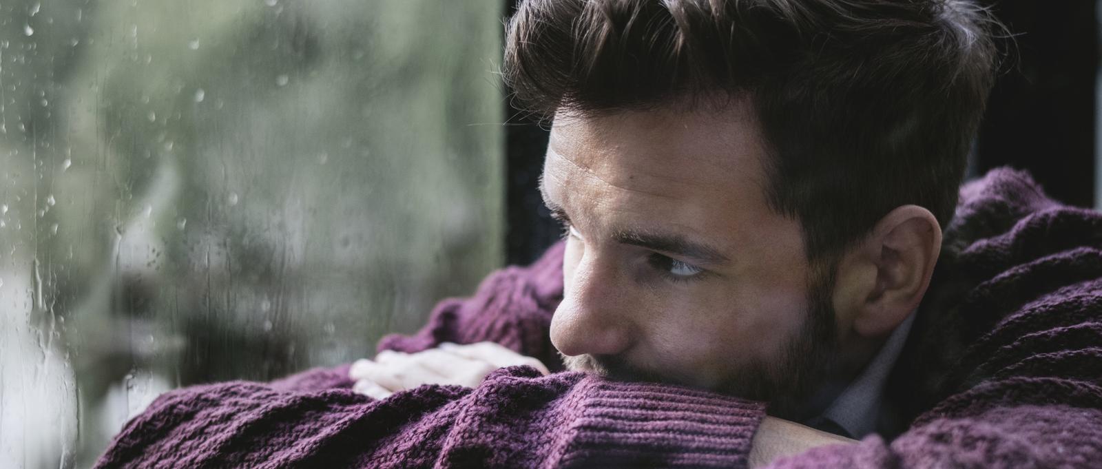 Thoughtful man looking out of the window